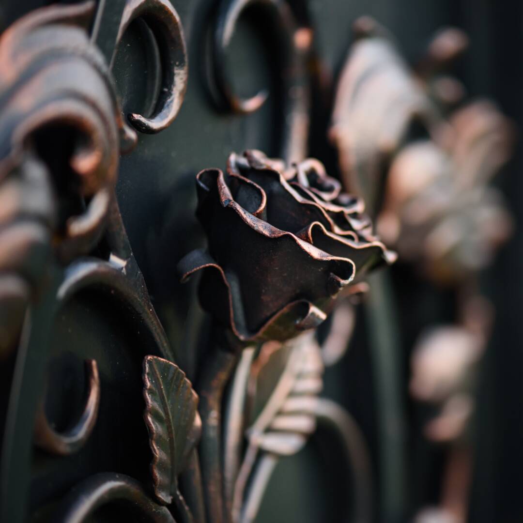 Wrought iron rose flower as decoration element, close up view. Manufacturing forged elements and products.